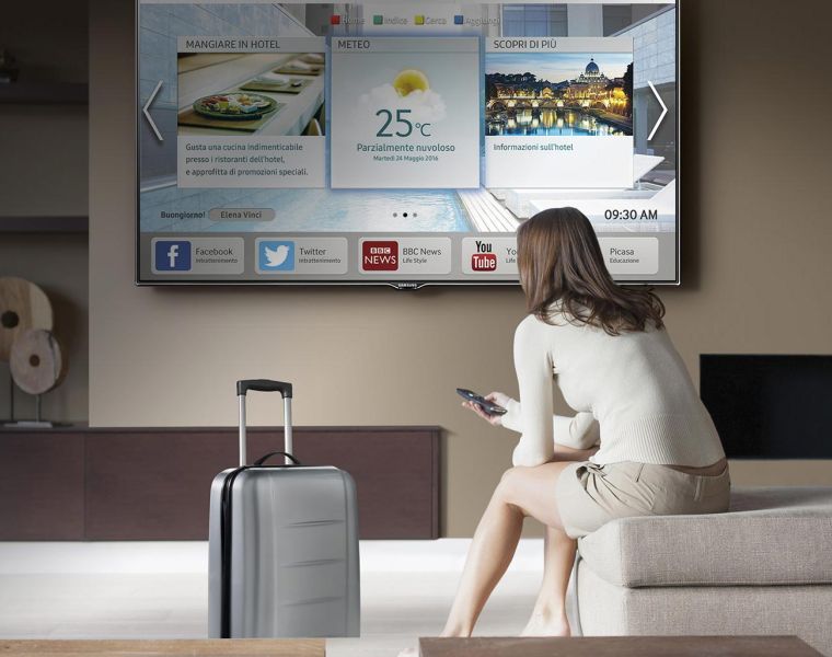 giovane donna in hotel interagisce con il display samsung smart signage